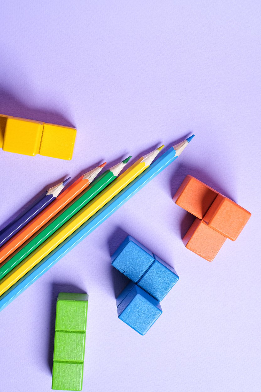 Building Blocks and Pencils on Lilac Background