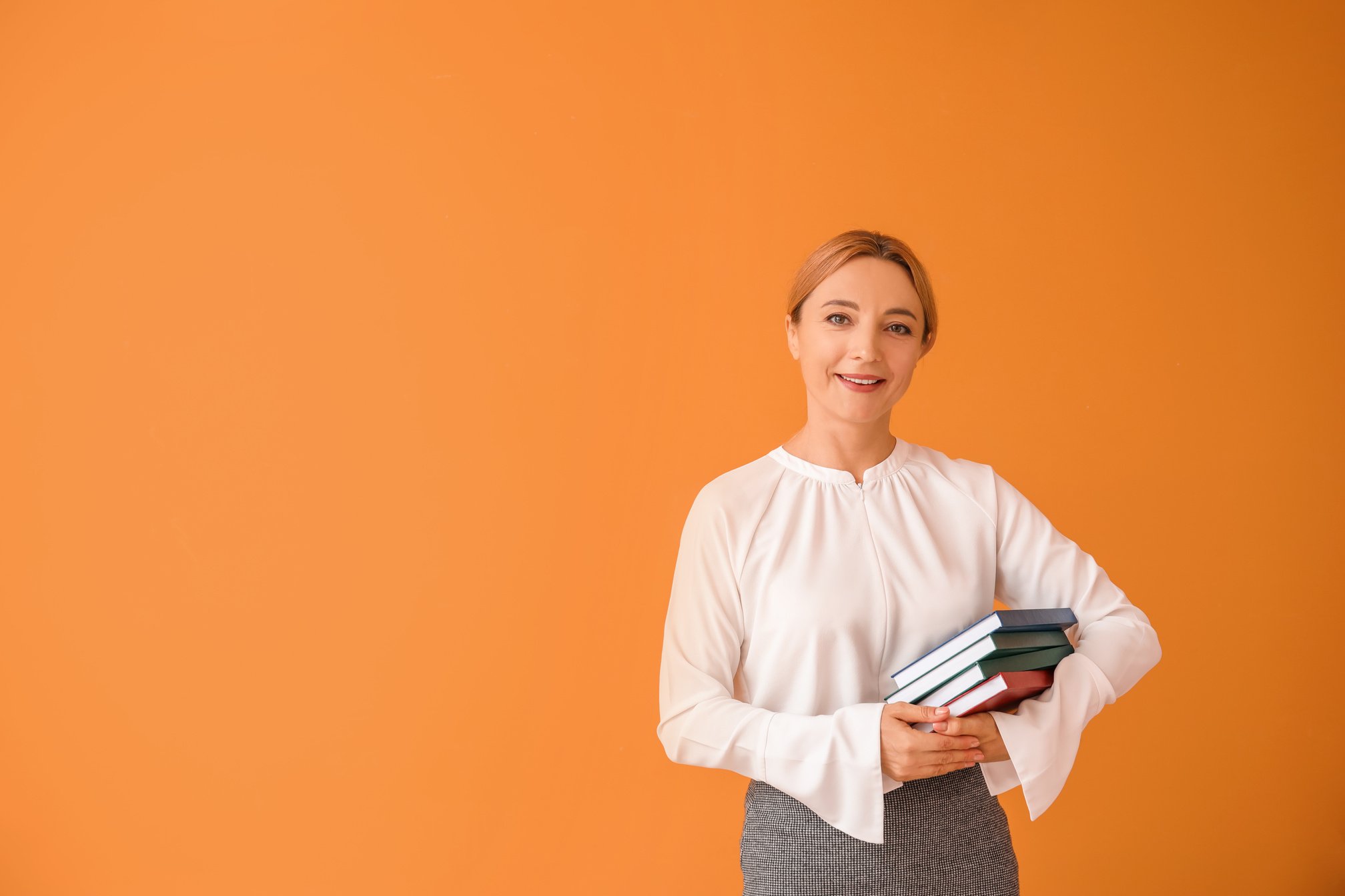 Portrait of Female Teacher on Color Background